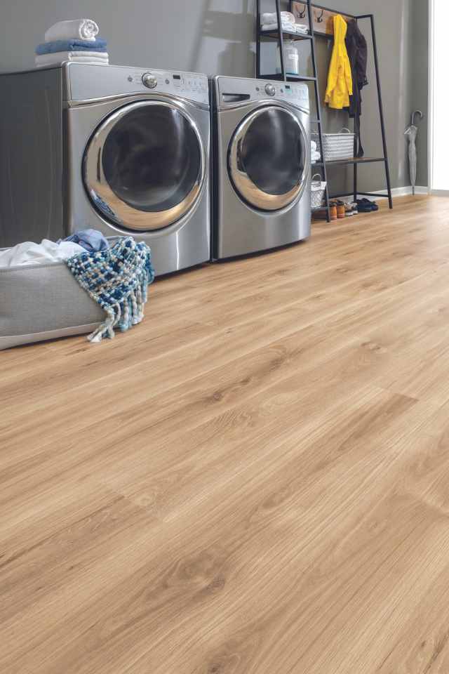 light wood look laminate in laundry room with basket of clean clothes